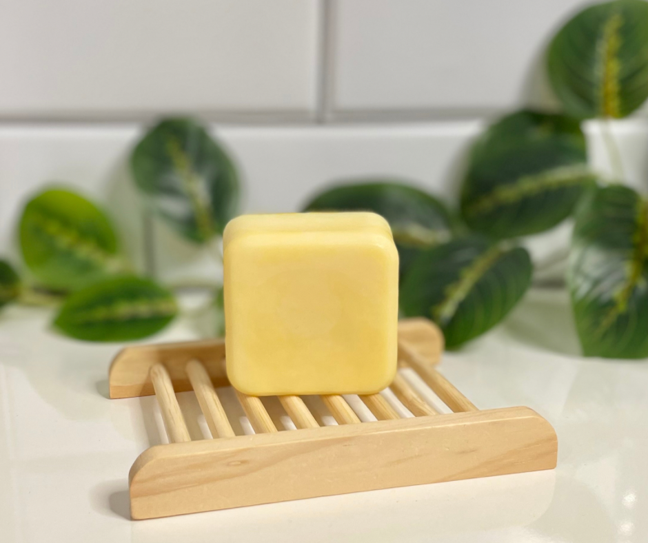 Square conditioner bar on wooden soap tray