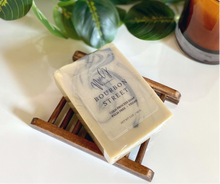 Load image into Gallery viewer, Tan and black soap bar laying on soap tray
