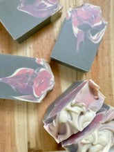 Load image into Gallery viewer, Gray, pink, purple, and white swirled soap bars on wood background
